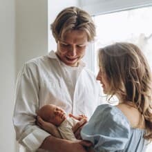 New parents holding their newborn